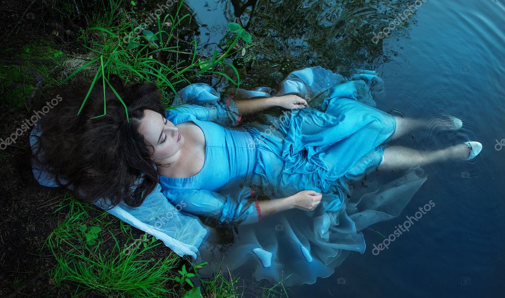 Young beautiful drowned woman lying in the water Stock Photo by ...