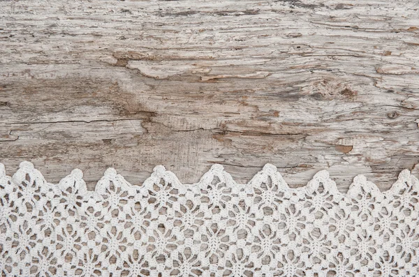 Lace fabric on the old wood — Stock Photo, Image