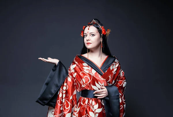 Beautiful Young Woman Red Traditional Chinese Costume Showing Something Empty — стокове фото