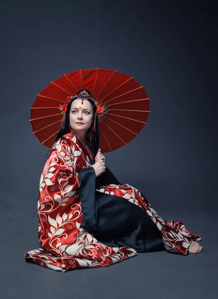 Beautiful Young Woman Red Traditional Chinese Costume Umbrella Sitting Floor — стокове фото
