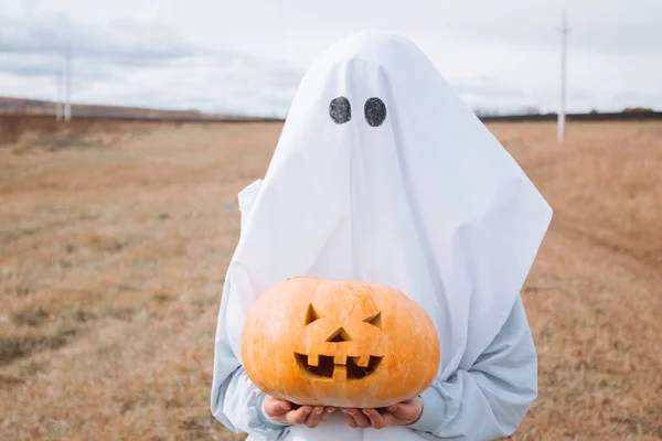 Girl Ghost Costume Halloween Holding Carved Pumpkin Autumn Field — Stok fotoğraf