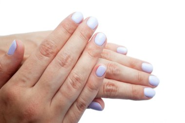 Hands with fresh manicure of a woman on a white background.