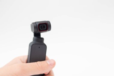 Man hand holding Action Camera video gimbal stabilizator on white background.