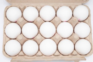 Fresh eggs on paper egg box, top view.