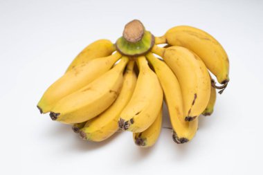 Bunch of yellow tropical bananas on white background.