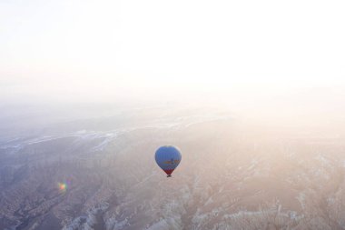 Hot air balloons over the mountainous terrain. Aerial photography