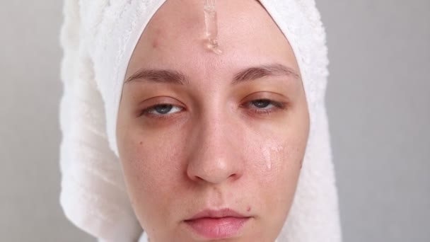 Beautiful Young Woman Applying Skincare Serum Her Face — Stockvideo
