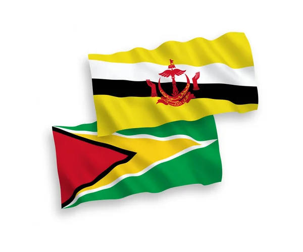Vlajky družstevní republiky Guyana a Brunej na bílém pozadí — Stockový vektor