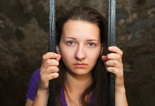 Mujer joven tras las rejas — Foto de Stock