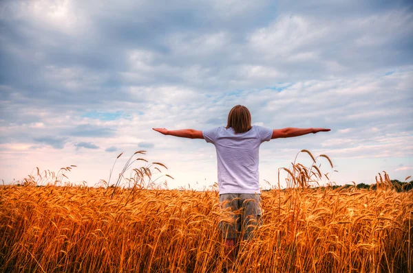 Young man staying with raised hands — Stock Photo, Image