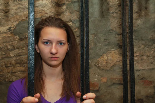 Young woman behind the bars — Stock Photo, Image