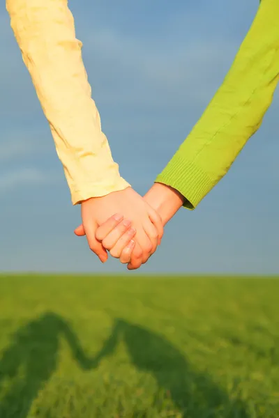 Teen girls holding hands — Stock Photo, Image