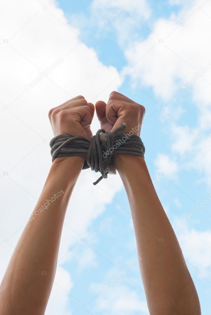 Three pairs of human hands tied up together