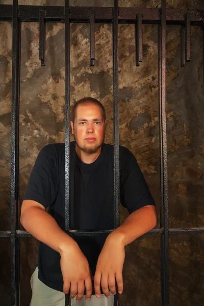 Young man behind the bars — Stock Photo, Image