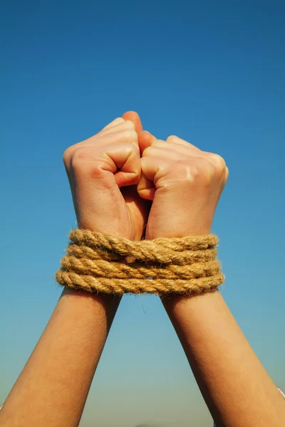 Hands tied up with rope — Stock Photo, Image