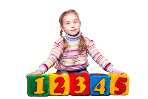 Happy girl holding blocks with numbers — Stock Photo, Image
