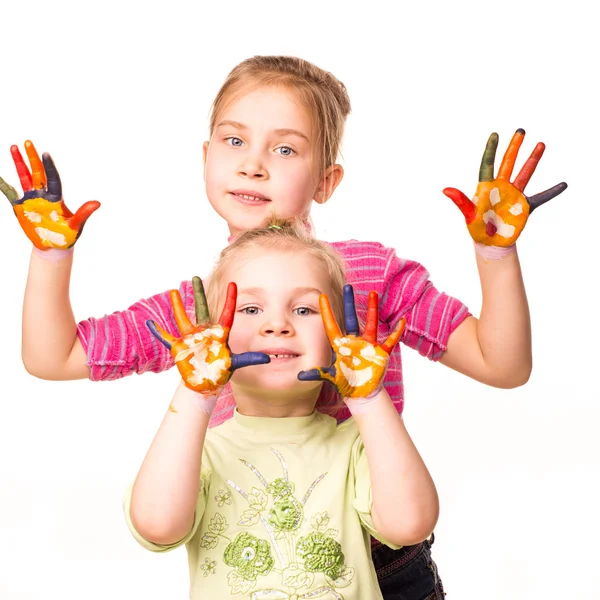 Two happy girls showing hands painted in bright colors — Stock Photo, Image