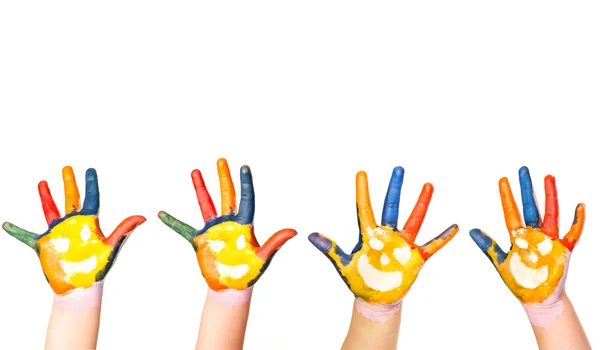 Kids hands in colorful paint with smiles — Stock Photo, Image