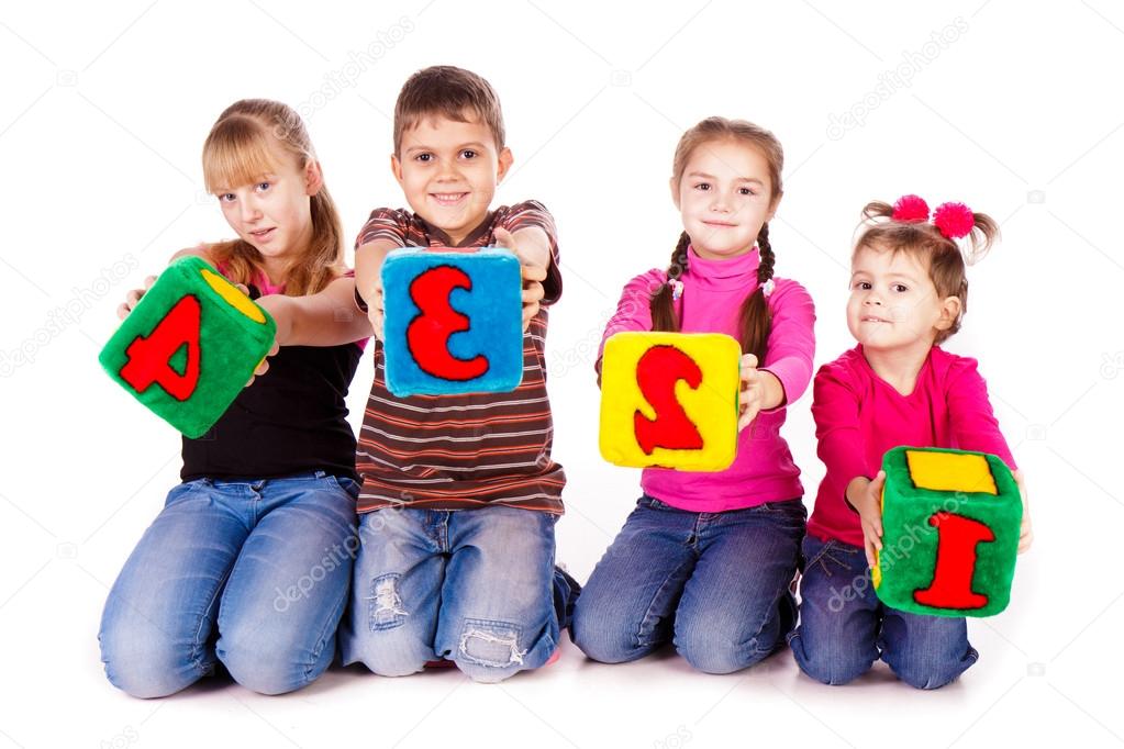 Happy kids holding blocks with numbers