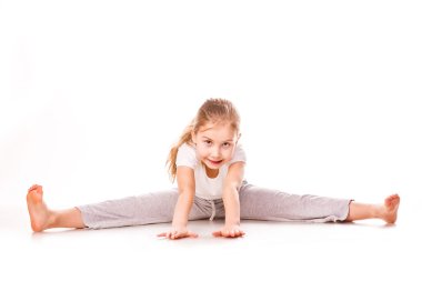 Beautiful girl gymnast exercising, stretching