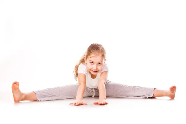 Beautiful girl gymnast exercising, stretching — Stockfoto