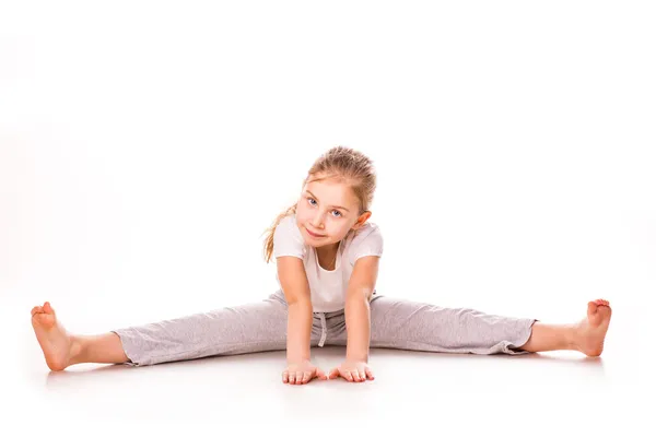 Beautiful girl gymnast exercising, stretching — Stock Photo, Image