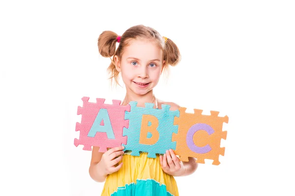 Chica feliz sosteniendo letras del alfabeto ABC — Foto de Stock