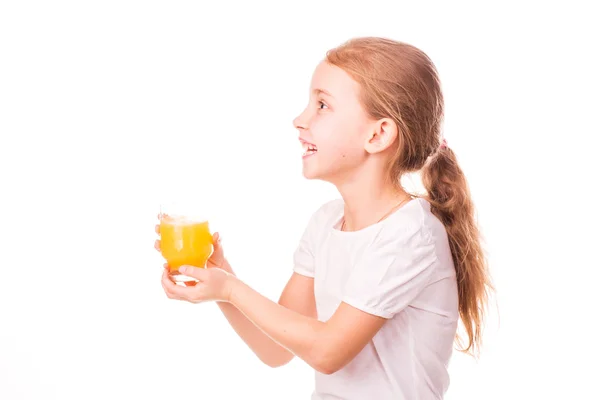 Cute little girl holding glass with juice smiling — Stock Photo, Image