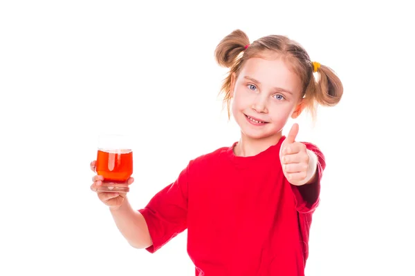 Nettes kleines Mädchen, das Glas mit Saft lächelnd hält — Stockfoto