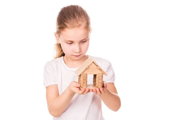 Bella bambina che tiene in mano una casa modello giocattolo. Comprare un concetto di casa . — Foto Stock