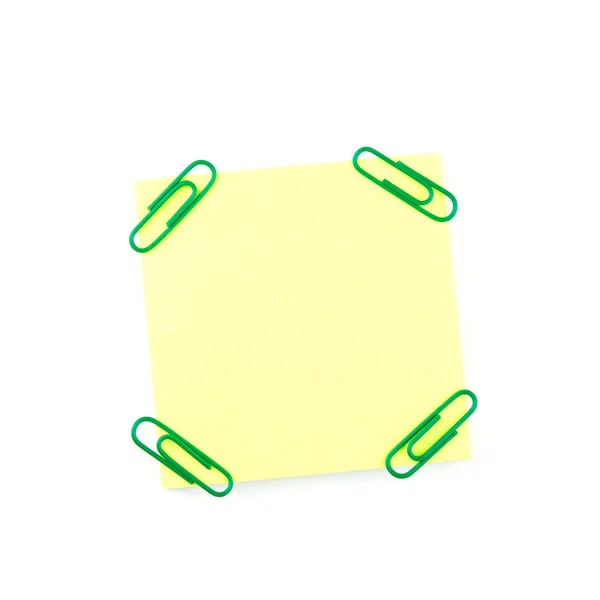 Geel papier opmerking met groene clips — Stockfoto
