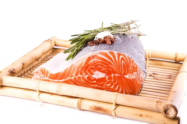 Filete de salmón crudo con romero en una tabla de bambú — Foto de Stock