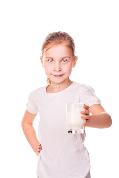 Beautiful little girl holding a glass of fresh milk.