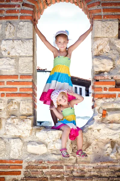 Beautiful little girls in ancient ruins of the Nesebar — Stock Photo, Image