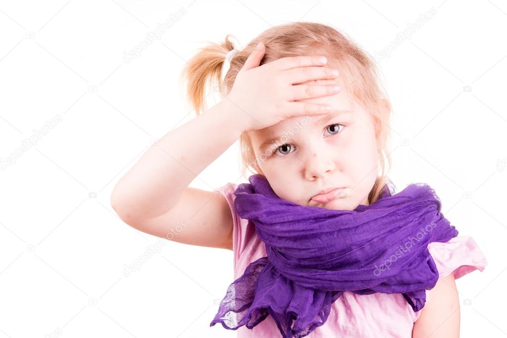 Sick little girl with chickenpox measuring temperature and checking her forhead