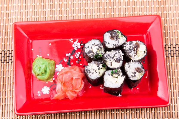 Vegetarian sushi roll served on a red plate — Stock Photo, Image