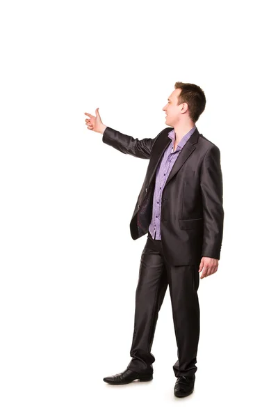 Gelukkig jonge vriendelijk lachende zakenman wijzende vinger — Stockfoto