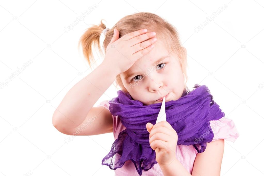 Sick little girl with chickenpox measuring temperature and checking her forhead