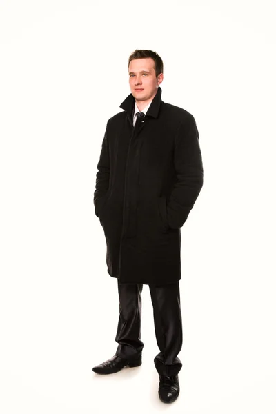 Красивый молодой бизнесмен в изолированном пальто — стоковое фото