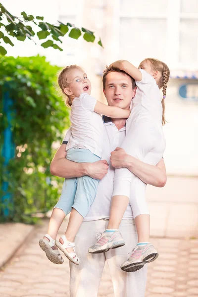 Happy young father holding his kids outdoor — Stock Photo, Image