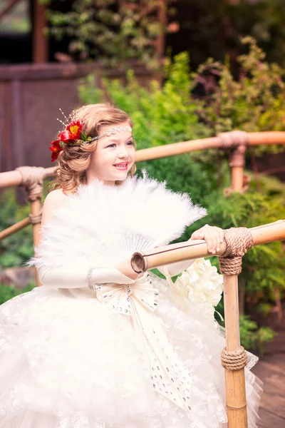 Charming little girl in a beautiful dress outdoor — Stock Photo, Image