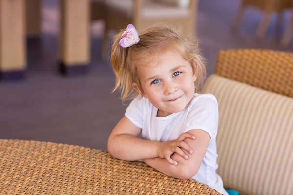 Cute little child at the table in a restaurant — Stock Photo, Image