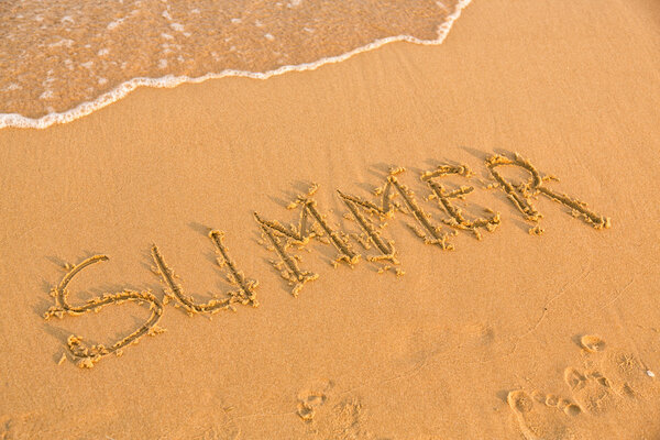 Word summer on the yellow sandy beach