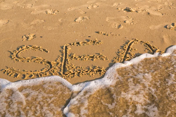 Word sea on the yellow sandy beach — Stock Photo, Image