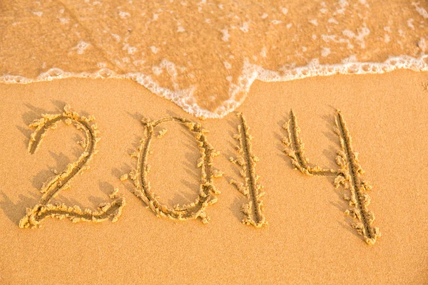 2014 numbers on the yellow sandy beach Stock Photo