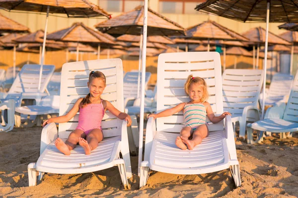 Dos niños adorables tomando el sol en una playa —  Fotos de Stock