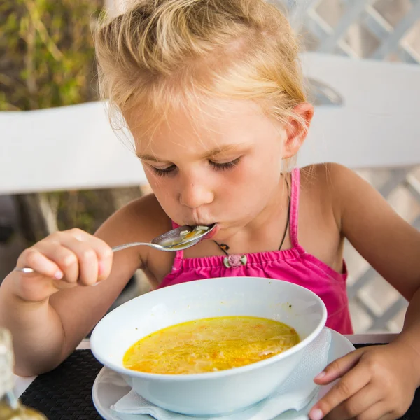 Cute child eating soup — Stock Photo, Image