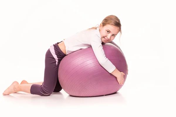 Sportive girl on a fit ball isolated over white — Stock Photo, Image