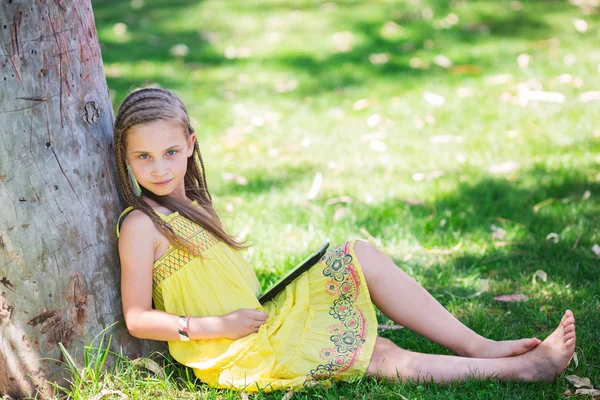 Cute little girl learning with tablet pc — Stock Photo, Image