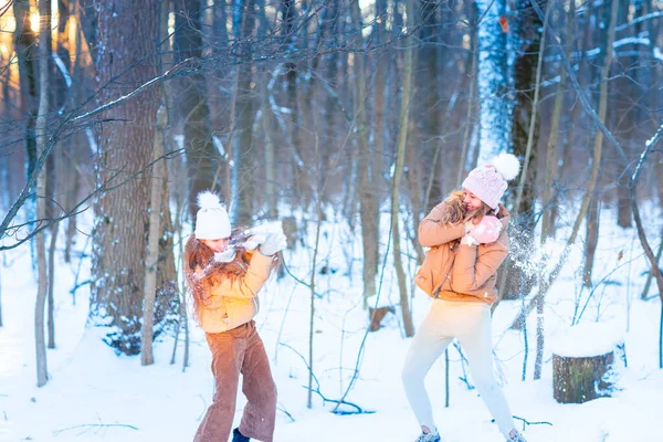 Two Teenage Girls Having Fun Playing Snow Throwing Snowballs Having — стоковое фото